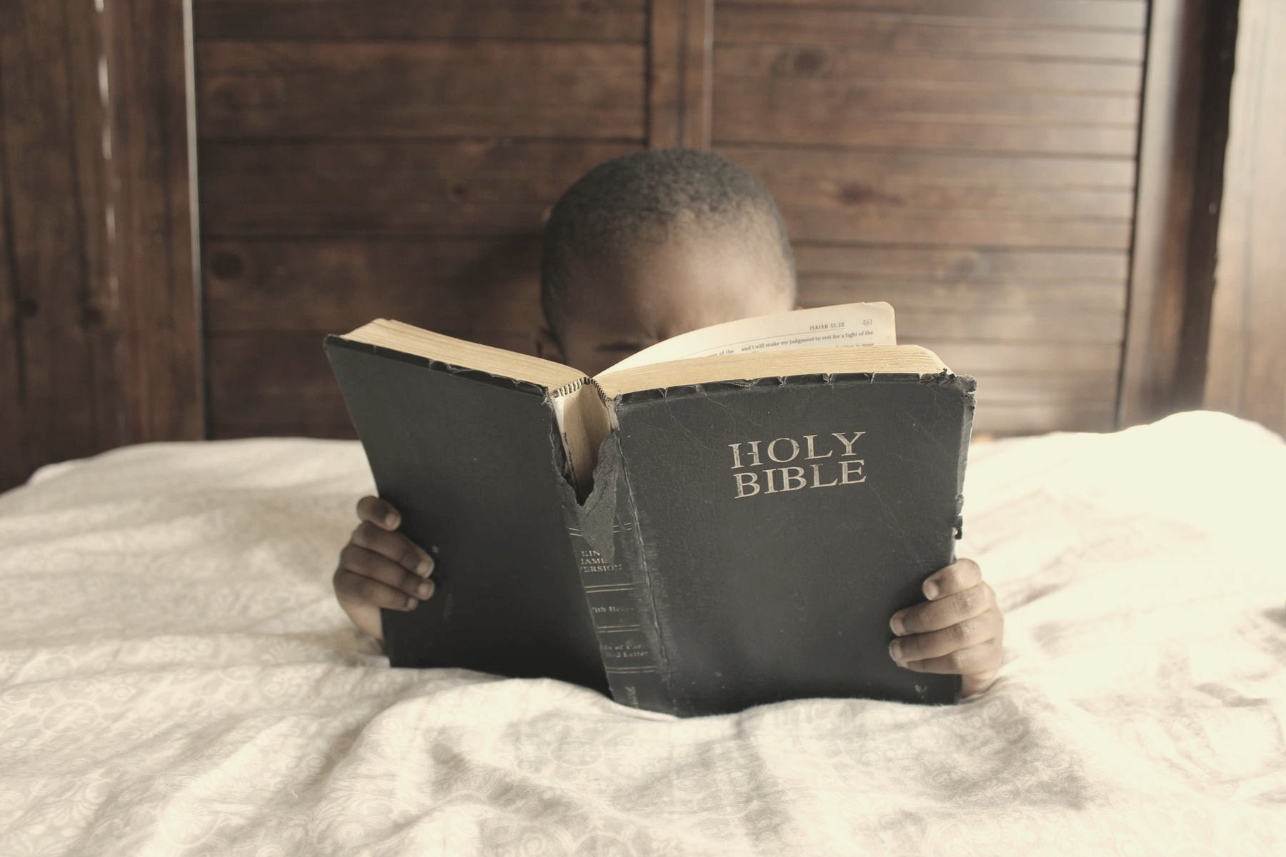 A person reading, hands resting on the pages