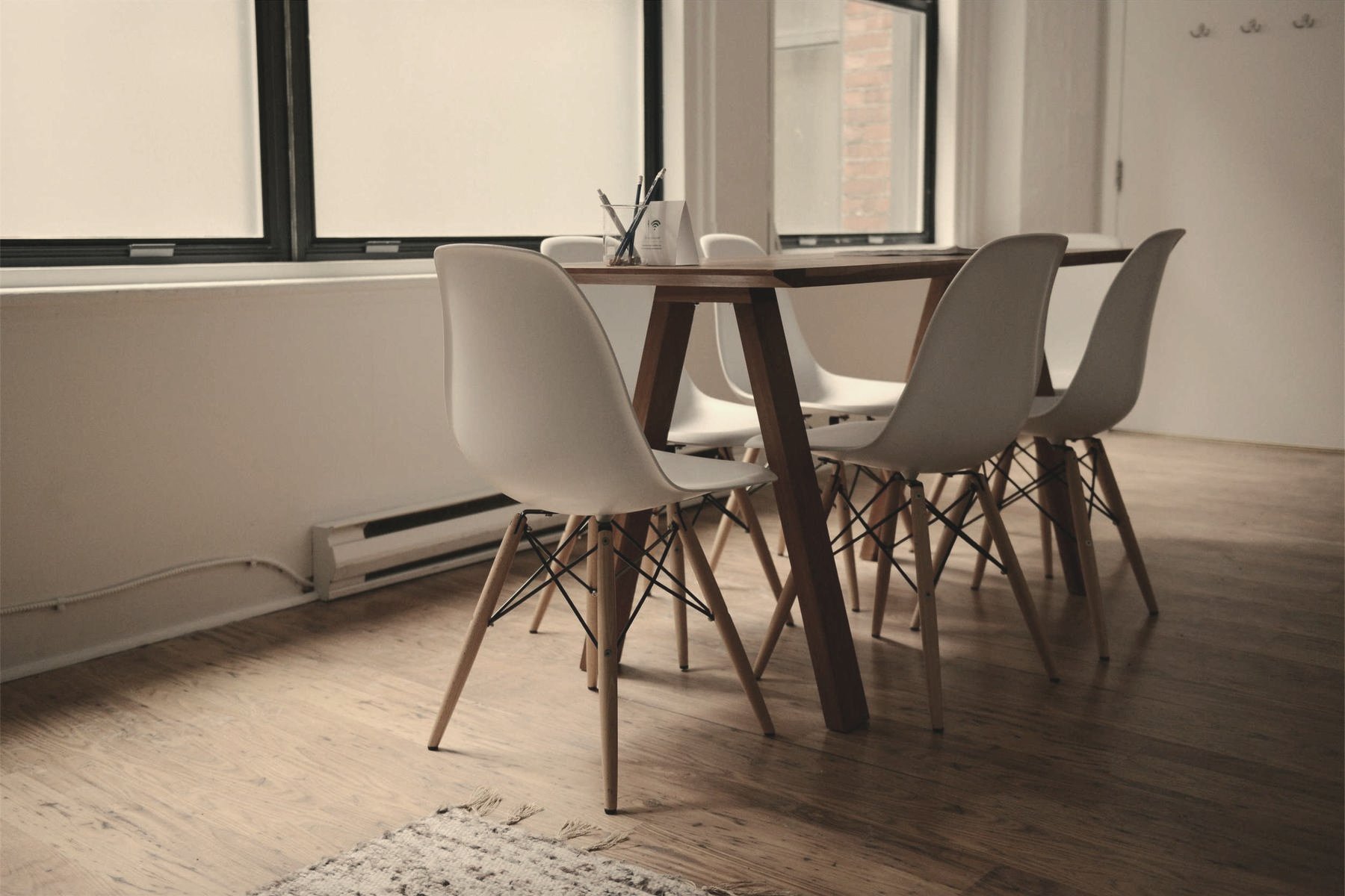 A table and four chairs in a bright, quiet room