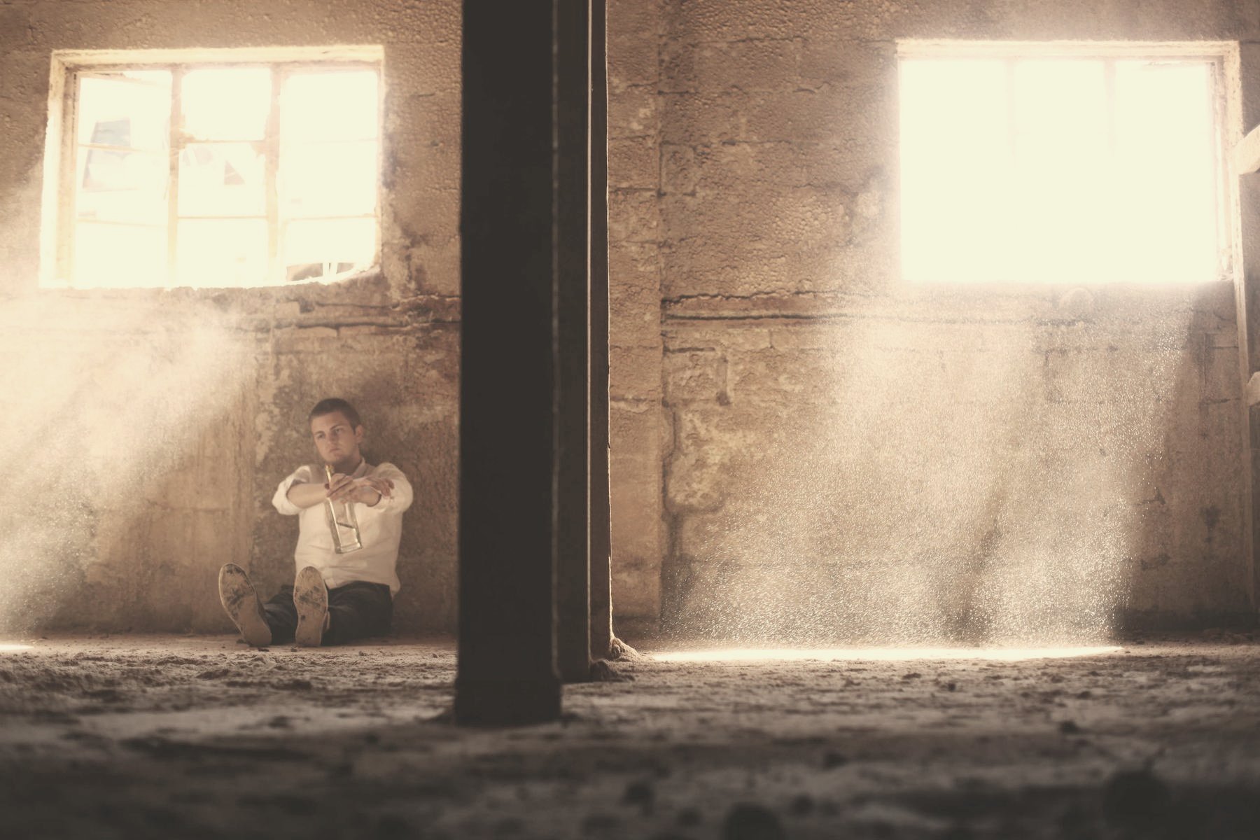 Light falling through a high window into an empty room